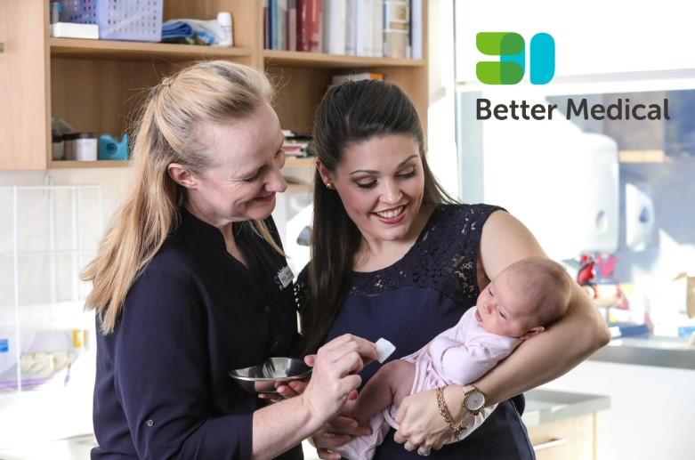 Woman holding baby with nurse