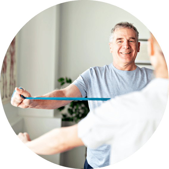 Man smiling while completing exercises with stretch band