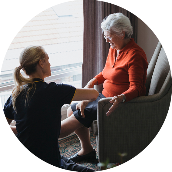 Allied health worker assists older woman in home